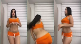 A morena gata Laura Natali se jogando na dança com um shortinho laranja
