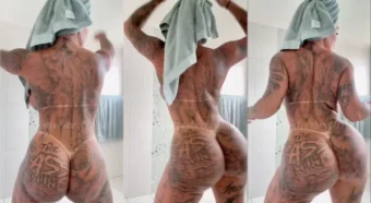Anny Alves toda tatuada, de toalha, exibindo todo seu charme e rebolado