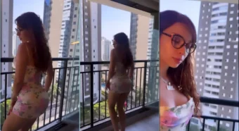 Cibelly Ferreira balançando a saia do vestido curto na varanda