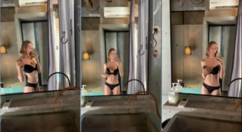 Yourina se posiciona na frente do espelho, exibindo toda a sua beleza irresistível